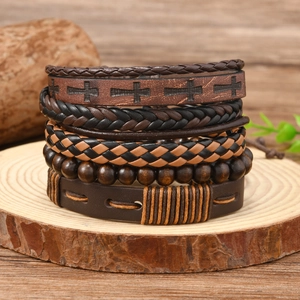 Detail of bohemian multilayer leather bracelets with wood beads on a wooden stand