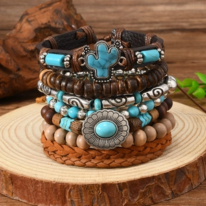 Detail of bohemian leather bracelets with wooden beads and silver cactus charms