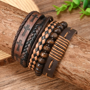 Macro shot of 5-piece retro layered leather bracelet set with wooden beads on timber