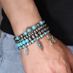 Detail of bohemian multilayer beaded bracelet set with turquoise beads and feather charms