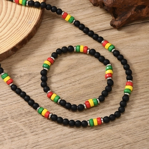 Detail of bohemian handmade beaded necklace with rasta colors on a wooden background