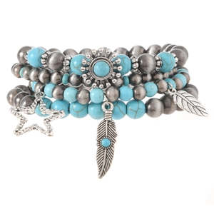 Detail of bohemian turquoise beaded bracelet set with sun, star and feather charms