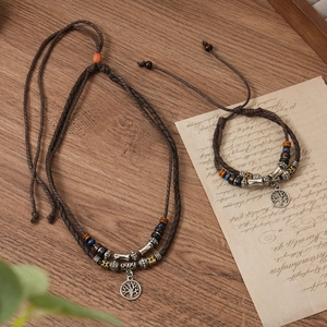 Detail of vintage layered woven necklace and bracelet set with Tree of Life pendant