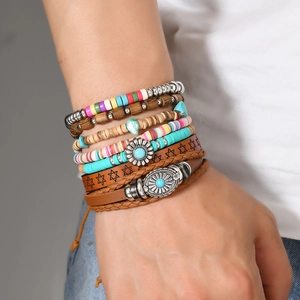 Detail of bohemian multilayer bracelet with turquoise beads and embossed leather