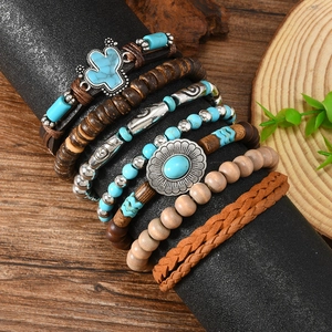 Detail view of Bohemian multilayer bracelets with wood beads, cactus charm and leather cord
