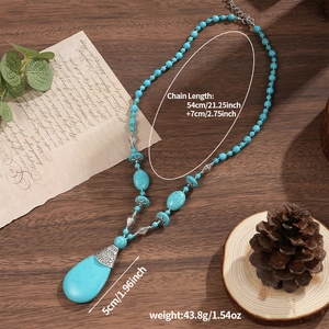Bohemian turquoise beaded necklace featuring a teardrop pendant on dark wood background