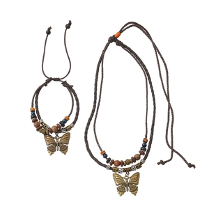 Detail of bohemian braided necklace with vintage metal butterfly pendant and beads