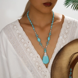 Bohemian turquoise beaded necklace featuring a large teardrop pendant and silver accents