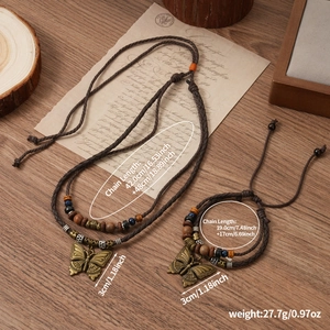 Detail of vintage bohemian jewelry set with bronze butterfly charms on woven cord