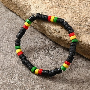 Macro shot of bohemian colorful wooden beads necklace on rustic stone and pavement
