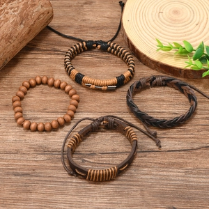 Macro shot of 4-piece bohemian layered bracelets with wood beads and woven leather detailing
