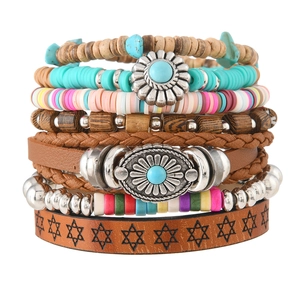 Detail of bohemian layered bracelet set with turquoise stones and wooden beads