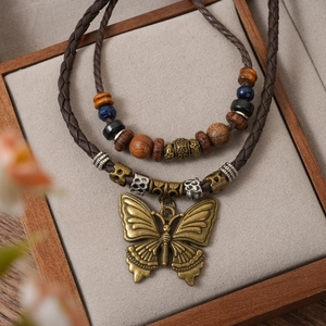 Vintage multilayer woven necklace with bronze butterfly pendant and ethnic style wood beads