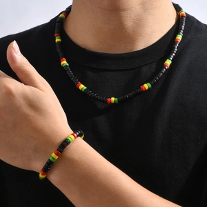 Detail of colorful Rasta style beaded necklace and bracelet set on a female model