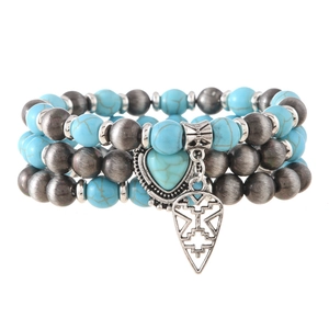 Detail view of Bohemian turquoise beaded bracelet set with heart and triangle charms