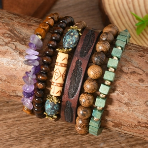 Detail view of multi-layer Bohemian bracelets with purple stone, wood beads and leather strap