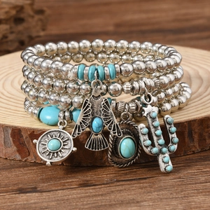 Detail of bohemian turquoise beaded bracelet set with cowboy hat and cactus pendants