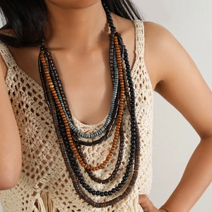 Détail d'un collier bohème multicouche avec perles en bois et turquoise sur modèle