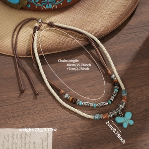 Bohemian double-layer necklace featuring a turquoise butterfly pendant on rustic wood