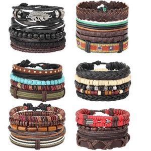 Detailed view of 26-piece ethnic braided bracelets with wood beads and leaf pendants