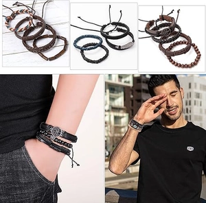 Detail of multi-layer leather bracelets with tree of life charms and wooden beads