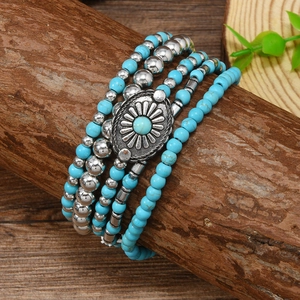 Bohemian multi-layer blue beaded bracelet set with turquoise floral charm on a branch