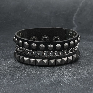 Punk leather bracelet featuring layered metal chains and silver studs with snap buttons