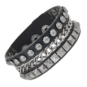 Detail of 4pcs punk layered bracelet with silver pyramid studs, chains and black leather