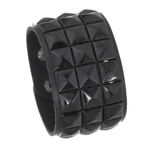 Detail view of black punk leather bracelet featuring triple rows of square metal studs