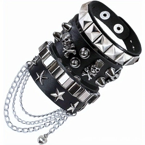 Detail of 4-piece punk leather bracelets with metal studs, skulls, and hanging chains