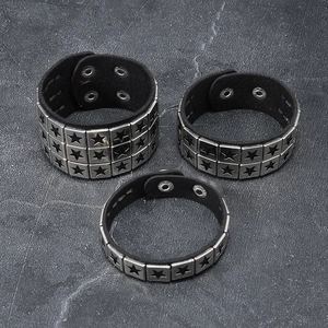 Three-piece punk black leather bracelet set with silver star studs on dark background