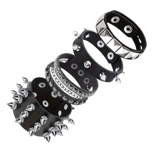 Detail of four-piece punk set with silver metal studs and chains on black leather wristbands