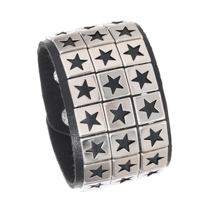 Detail of black leather punk bracelet featuring four rows of star-hollowed metal rivets