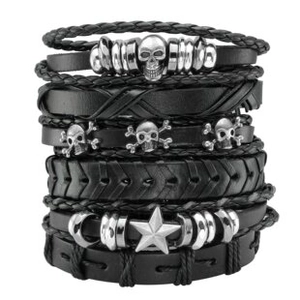 Macro detail of multi-layer leather punk bracelet with silver skulls and star studs