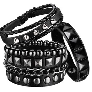 Close-up of punk rock studded leather bracelets showing metal spikes and woven texture