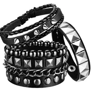 Close-up of 3-piece punk leather bracelet set with metallic studs and braided ropes