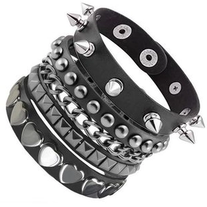Detail view of 3-piece punk leather bracelets with metal studs, spikes, and silver chains