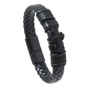 Close-up of black braided leather men's bracelet with metal cross and magnetic clasp