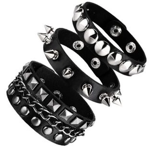 Detailed view of 3-piece punk leather bracelet set with metallic studs and sharp spikes