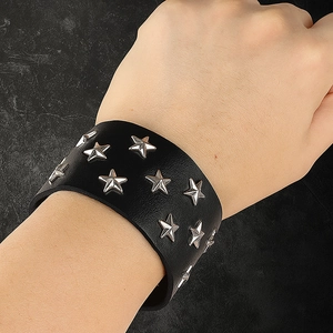 Punk rock style wide black leather wristband featuring silver star rivets and snap buttons