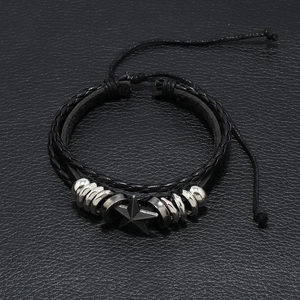 Detailed shot of double-layer braided leather bracelet with star charm and adjustable knot