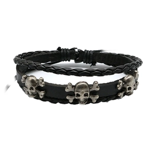 Detail of multi-layer black leather bracelet with silver skull and crossbones metal studs