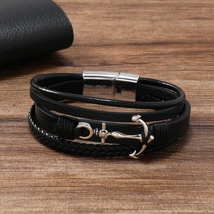 Close-up of men's leather anchor bracelet on wood with stainless steel magnetic clasp