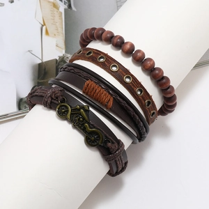 Close-up of multilayer leather bracelets and wood beads with vintage motorcycle charm