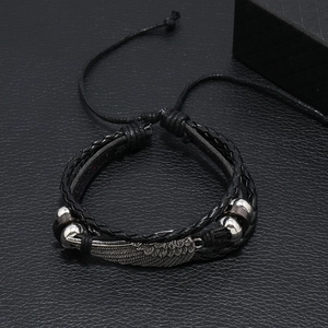 Adjustable black leather woven bracelet featuring a vintage silver alloy wing pendant charm