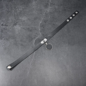 Detail of black leather punk choker with adjustable metal snaps and circular pendant