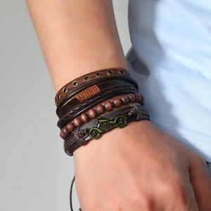 Detail of multi-layer leather bracelet set with vintage bronze motorcycle charm