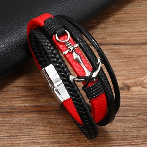 Detail of red and black braided leather bracelet with silver anchor and magnetic clasp