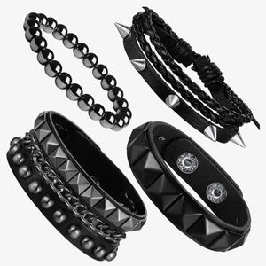 Detailed view of 4-piece punk bracelet set with black leather, studs and chain links