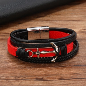 Detail showing red and black multilayer leather strands with silver anchor charm and magnetic clasp